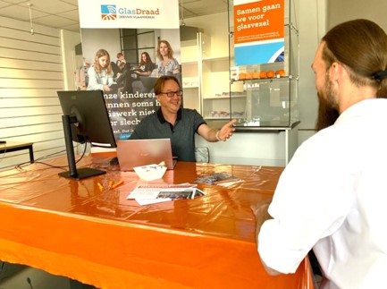 twee mensen in gesprek aan tafel